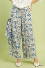 Beige umgee linen printed wide leg pants with blue leafy pattern and raw hem frayed edges