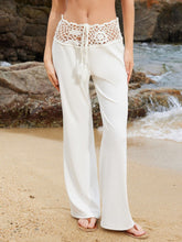 White wide leg pants with a cream crochet waist wide waistband and drawstring tie featuring an intricate pattern