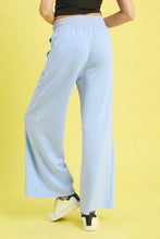 Light blue umgee drawstring wide leg pants made of soft stretchy fabric with subtle side seam detailing and scallop trim