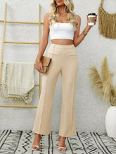 Beige high waist flare pants with a tailored fit and front flap pockets in a sleek wide-leg design