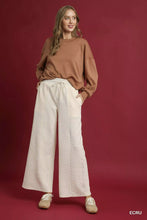 Cream-colored umgee cable knit textured wide leg pants with woven pattern and drawstring waist for comfortable wear