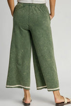 Olive green umgee mineral wash wide leg pants with white lace applique trim at the hem plus size