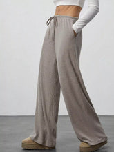 Beige ribbed corduroy relaxed fit wide leg pants with a drawstring waist for comfortable leg pants style