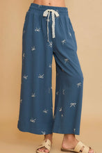 Umgee blue wide-leg pants feature white embroidered bows and a lace drawstring waistband in plus size design