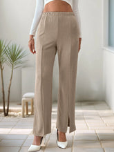 Beige ribbed high-waisted slit pants with wide-leg design, front slit, and elastic waistband for comfortable fit
