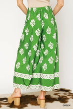Green umgee floral pleated wide-leg pants with white floral pattern lace trim and elastic waistband machine wash tumble dry