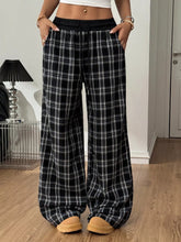 Black and white plaid wide-leg pants with elastic waistband made from soft fabric for comfortable everyday wear