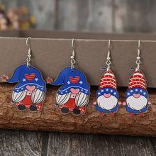 Four pairs of acrylic gnome dangle earrings with blue and striped hats