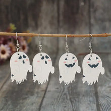 Four ghost dangle earrings in alloy acrylic hanging from branch