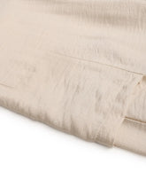 Beige linen drawstring wide leg pants with subtle texture and visible stitching machine wash cold instructions