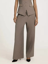 Taupe striped wide leg pants with subtle vertical pinstripes and structured tailoring in a matching blazer set