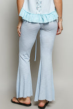 Light blue flare pants with a textured ribbed design and drawstring waist made of breathable knit fabric