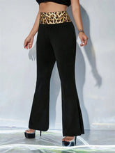 Black high waist flare pants featuring a bold leopard high waist waistband for a stylish waist flare look