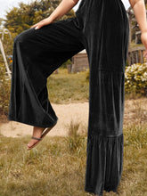 Plus size velvet ruffle hem wide leg pants in black velvet with tiered ruffled hem and elastic waistband