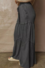 Dark gray mineral wash tiered wide leg pants with drawstring waist and frayed hem details in unique mineral wash design