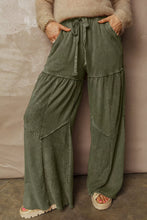 Olive green tiered wide leg pants with patchwork design and drawstring waistband for casual wear