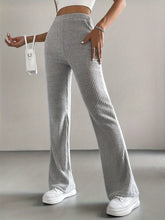 Gray ribbed knit high waist flare pants showcasing a comfortable fit and stylish waist flare design