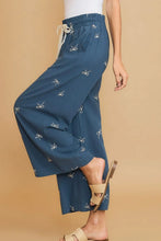 Blue wide-leg pants with white embroidered bow patterns and a lace drawstring waist by umgee full size plus size