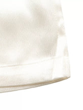 Cream-colored satin wide-leg pants with lace waist and smooth glossy finish featuring a neatly stitched hem