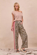 BiBi leopard print pants with wide-leg fit and red and white striped side panels featuring tucking welt pockets