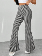 Black and white houndstooth high waisted flare pants with a distinctive flared silhouette and stylish pattern