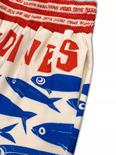 Plus size printed wide leg cream shorts with bold red and blue fish graphics and red elastic waistband
