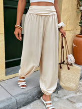 Cream-colored ruched high waist joggers in soft flowing fabric with elastic cuffs and high waist silhouette
