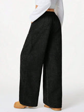 Black corduroy drawstring wide-leg pants with a relaxed high-waisted fit and machine wash care instructions