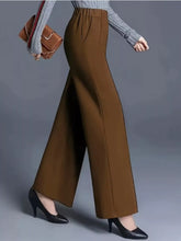 Brown wide-leg pants with a high waist and tailored fit suitable for tumble dry care instructions