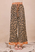 Wide-leg bibi leopard print trousers in orange and beige with drawstring waistband and floral hem trim