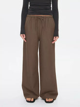 Brown wide leg drawstring pants with elastic waistband designed for comfort and a relaxed fit