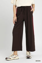 Umgee wide leg pants in brown with a drawstring waist and red contrast side trim for casual wear