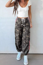 Camo print drawstring waist joggers with red and white striped side panels, elastic waistband, and tapered ankles