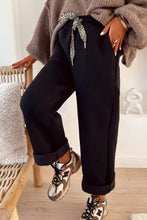 High-waisted straight black wide-leg joggers with adjustable leopard-print drawstring waist machine wash cold care instructions