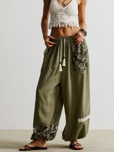 Olive green lace detail drawstring harem pants with wide-leg fit and floral embroidery on side pocket and hem