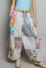 Pol printed patchwork wide leg pants featuring vibrant floral and striped fabrics on white base with adjustable drawstring