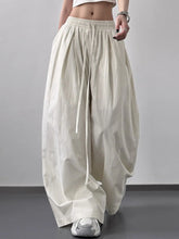 Cream-colored striped wide leg drawstring pants with elastic waistband and vertical stripes for comfortable wear