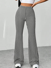 Black and white houndstooth high waisted flare pants with a stylish flared silhouette for a chic look