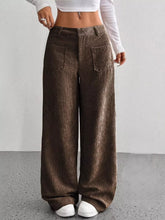 Brown corduroy wide leg pants with ribbed corduroy texture and two front pockets, styled with ankle boots