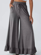 Gray ruffled wide leg pull on high waist pants with drawstring waistband and ruffled hem with pockets