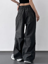 Black wide leg cargo pants with elastic waistband and single front pocket ideal for casual wear