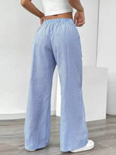 Light blue and white striped wide leg pants with elastic waistband perfect for casual and comfortable wear