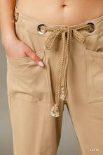Beige umgee cargo-inspired drawstring pants with front pockets and adjustable waistband for casual wear
