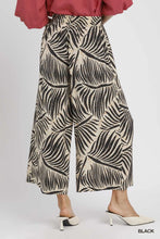 Umgee palm leaf print culotte pants featuring black and cream wide-leg palm leaf patterned fabric