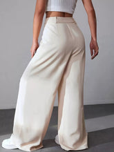 Cream-colored wide leg pleated pants made of smooth satin-like fabric with a high waistband for elegant wear