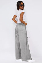 Gray tied pocketed wide leg pants with elastic waistband and side pockets in a comfortable wide leg style