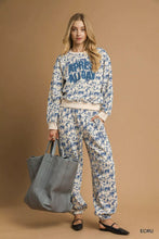 Gray leather tote bag complementing umgee scenic print casual sweatpants for stylish everyday use