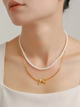 Elegant pearl necklace with bow necklace and extension chain length on woman’s neck