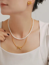 Elegant woman in 3-piece pearl necklace, bow necklace with extension chain and matching bow earrings