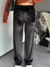 Black velvet wide leg pants with high waist and drawstring waistband for a stylish comfortable fit